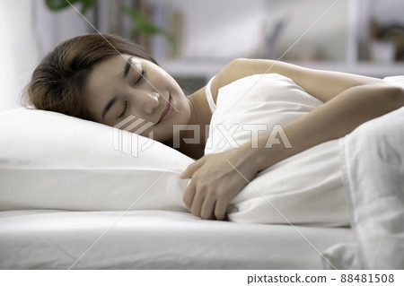 Asian woman sleep and sweet dream on bed in bedroom in the morning feeling so relax and comfortable Asian woman sleep and sweet dream on bed in bedroom in the morning feeling so relax and comfortable 88481508