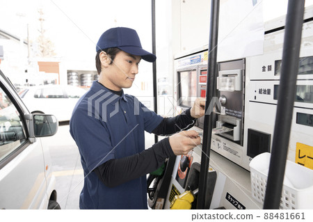 A man refueling at a self-service gas station A man refueling at a self-service gas station 88481661