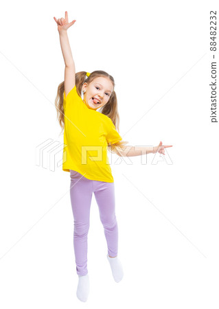 A happy and cheerful child dressed in a yellow T-shirt and purple pants plays, jumps. A happy and cheerful child dressed in a yellow T-shirt and purple pants plays, jumps. 88482232