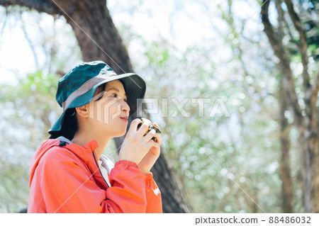 A woman eating rice balls in nature A woman eating rice balls in nature 88486032