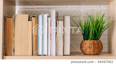 Old and new books standing on bookshelf next to the grass Old and new books standing on bookshelf next to the grass 88487062