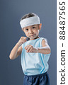 A young girl is practicing fighting and exercising. 88487565