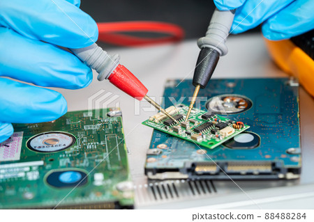 Technician repairing inside of mobile phone by soldering iron. Integrated Circuit. the concept of data, hardware, technology. Technician repairing inside of mobile phone by soldering iron. Integrated Circuit. the concept of data, hardware, technology. 88488284