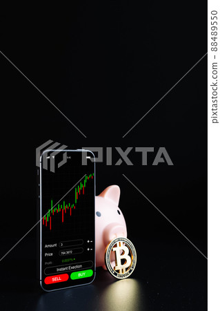 Crypto currency trading. Pink piggy bank, gold crypto currency BTC bitcoin, bitcoin wallet mobile phone application on black background. Save virtual money concept. 88489550