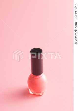 Colorful nail polish bottles on pink background. 88491046