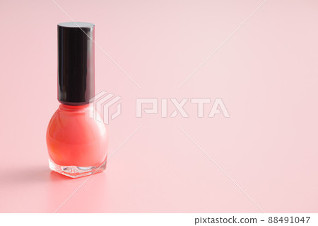 Colorful nail polish bottles on pink background. 88491047