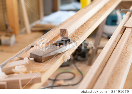 Planes and wood placed at the construction site 88491679