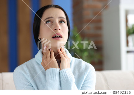 Sick woman with sore throat and inflamed tonsils Sick woman with sore throat and inflamed tonsils 88492336