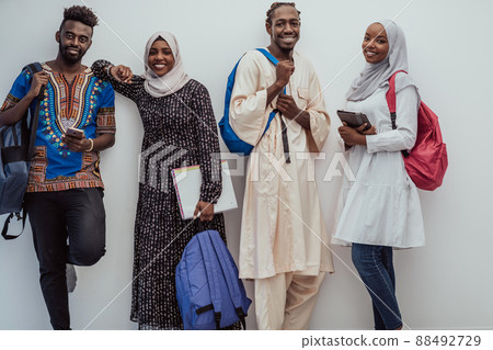 Photo of a group of happy african students talking and meeting together working on homework girls wearing traditional Sudanese Muslim hijab 88492729