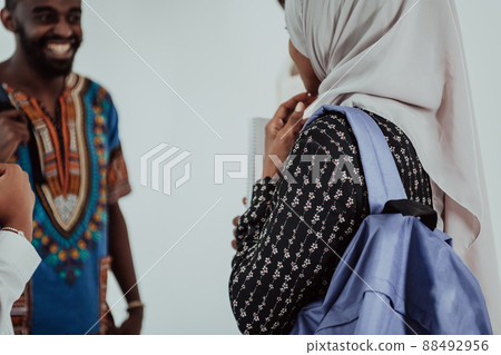 Group of happy african students having conversation and team meeting working together on homework girls wearing traidiional sudan muslim hijab fashion Group of happy african students having conversation and team meeting working together on homework girls wearing traidiional sudan muslim hijab fashion 88492956