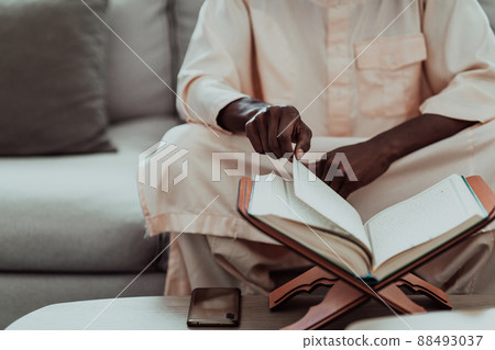 African Muslim couple at home in Ramadan reading Quran holly Islam book. 88493037