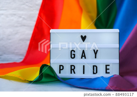 Rainbow flag with lightbox and text GAY PRIDE. Rainbow lgbtq flag made from silk material. Symbol of LGBTQ pride month. Equal rights. Peace and freedom Rainbow flag with lightbox and text GAY PRIDE. Rainbow lgbtq flag made from silk material. Symbol of LGBTQ pride month. Equal rights. Peace and freedom 88493117