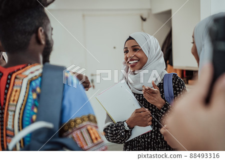 Group of happy african students having conversation and team meeting working together on homework girls wearing traidiional sudan muslim hijab fashion 88493316