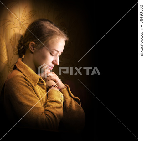 Young woman praying Young woman praying 88493833