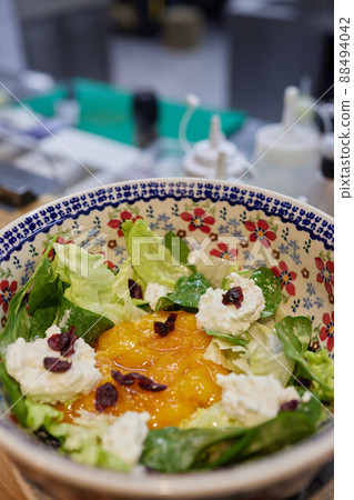 flat lay of plate with apricot, arugula and feta cheese salad on wooden table. flat lay of plate with apricot, arugula and feta cheese salad on wooden table. 88494042