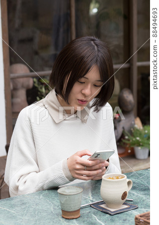 Woman relaxing in a cafe Woman relaxing in a cafe 88494693
