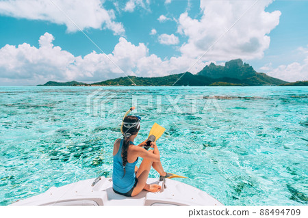 Snorkel diving excursion boat tour from yacht luxury travel influencer going swimming in coral reefs of Tahiti, French Polynesia Bora Bora island 88494709