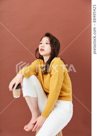 Young woman in knit girly fashion Young woman in knit girly fashion 88495425