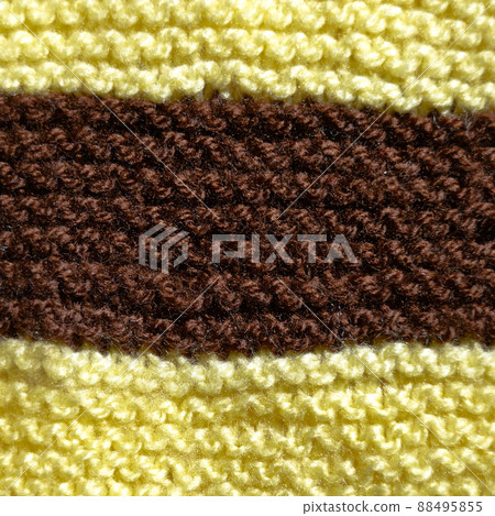 Handmade knitted fabric yellow and brown wool background texture 88495855
