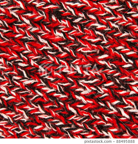 Handmade knitted fabric red black and white wool background texture Handmade knitted fabric red black and white wool background texture 88495888