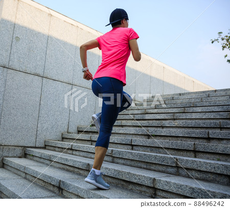 Fitness sports woman running up stairs in city 88496242