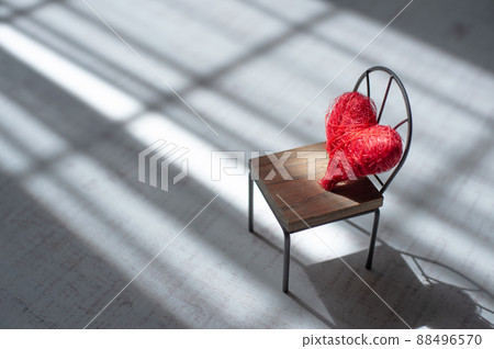 Chairs and heart accessories placed by the window 88496570