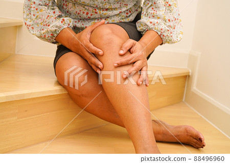 Asian lady woman injuries from falling down on slippery surfaces stairs at home. 88496960