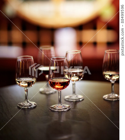 The many varieties of wine. Shot of wine glasses laid out for tasting at a wine cellar. 88499596