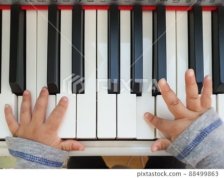 Little cute baby's hands playing the piano Little cute baby's hands playing the piano 88499863