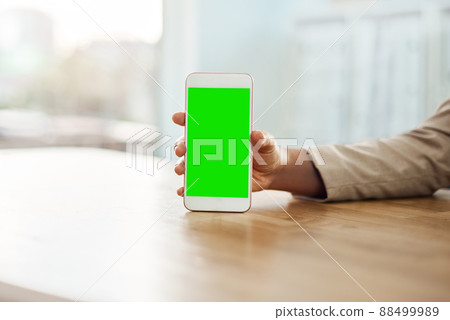 Always stay in the loop. Shot of an unrecognizable businesswoman using a mobile phone in her office. 88499989