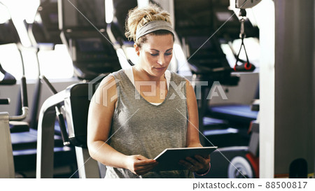 Tracking her progress with a fitness app 88500817