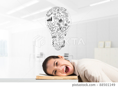 Business woman lying on desk with open mouth 88501149