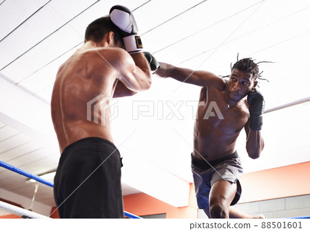 Training for the big day. Two kickboxers in training. 88501601