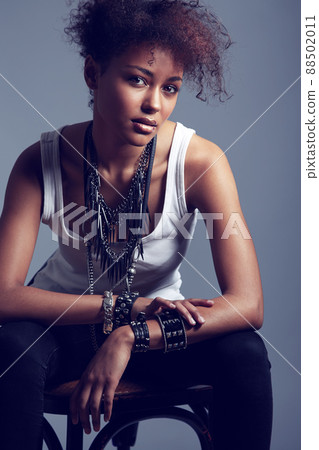 Rocker chic. A trendy young woman sitting on a chair. Rocker chic. A trendy young woman sitting on a chair. 88502011