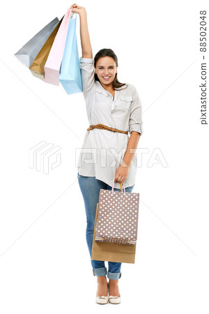 And I got it all on sale. Studio portrait of an attractive woman carrying many shopping bags isolated on white. And I got it all on sale. Studio portrait of an attractive woman carrying many shopping bags isolated on white. 88502048