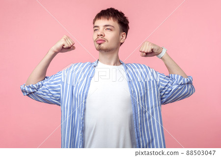 I can do this. Portrait of confident proud brown-haired man with small beard and mustache in casual striped shirt showing biceps, feeling power success. indoor studio shot isolated on pink background I can do this. Portrait of confident proud brown-haired man with small beard and mustache in casual striped shirt showing biceps, feeling power success. indoor studio shot isolated on pink background 88503047