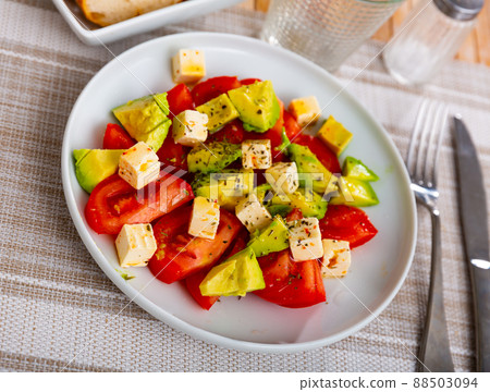 Colorful salad with tomatoes, avocado, feta and dried herbs Colorful salad with tomatoes, avocado, feta and dried herbs 88503094