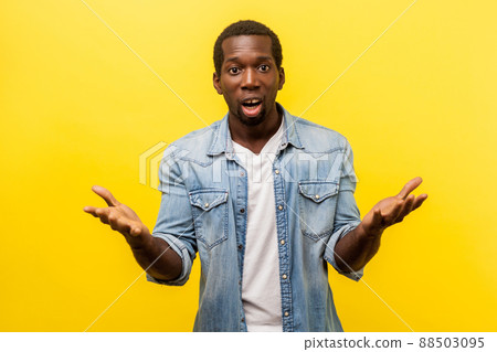 How could you. Portrait of unpleasantly surprised man in denim casual shirt standing with raised hands and amazed face asking why'd you do that, indignant annoyed expression. indoor studio shot How could you. Portrait of unpleasantly surprised man in denim casual shirt standing with raised hands and amazed face asking why'd you do that, indignant annoyed expression. indoor studio shot 88503095
