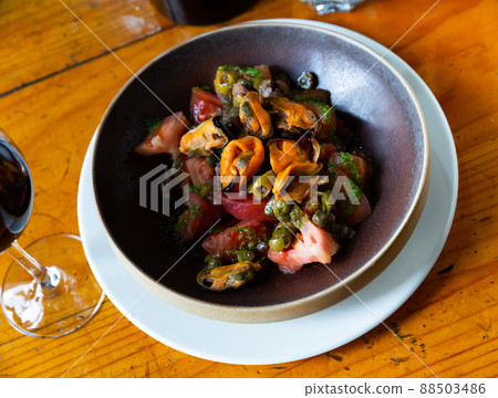 Tomatoes with pesto, mussels, olives and capers Tomatoes with pesto, mussels, olives and capers 88503486