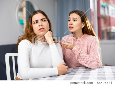 Young woman comforting her friend at home 88503571