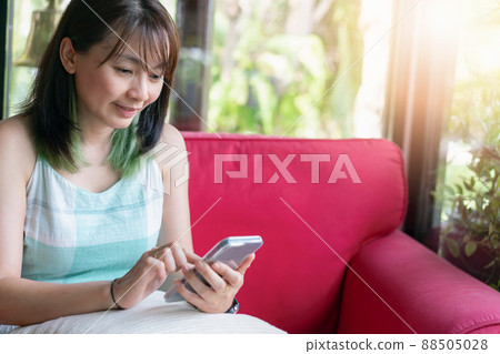 Happy woman use smartphone for communication and social network Happy woman use smartphone for communication and social network 88505028