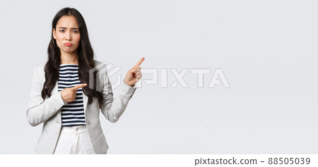 Business, finance and employment, female successful entrepreneurs concept. Upset gloomy young female office manager have failed, feeling uneasy and distressed, sulking as pointing upper right corner Business, finance and employment, female successful entrepreneurs concept. Upset gloomy young female office manager have failed, feeling uneasy and distressed, sulking as pointing upper right corner 88505039