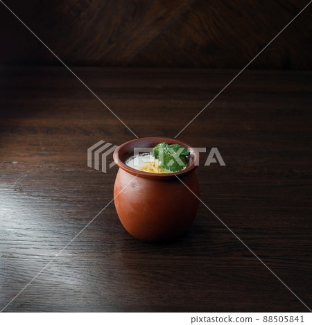 Sour-milk drink "Matsoni" in a ceramic pot in a restaurant. Traditional element of the Armenian and Georgian national cuisines. 88505841