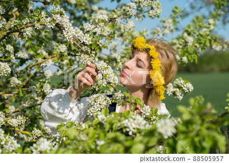 Beautiful feminime woman in national dress with white spring flowers 88505957