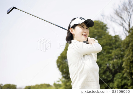 Golf girls hitting a tee shot 88506090