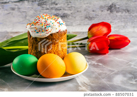 Easter cake, eggs and tulip flowers on kitchen table. Easter cake, eggs and tulip flowers on kitchen table. 88507031
