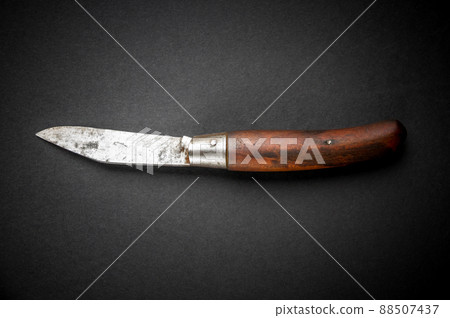 Traditional wooden pocket knife on black background 88507437