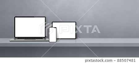 Laptop, mobile phone and digital tablet pc on grey wall shelf. Banner background 88507481