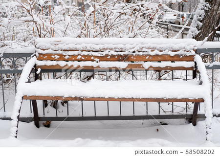 street bench in the snow. Heavy snowfall. Snowfall consequences. Streets without snow removal street bench in the snow. Heavy snowfall. Snowfall consequences. Streets without snow removal 88508202