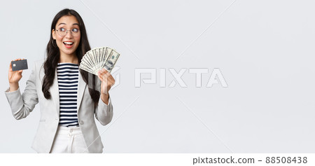 Business, finance and employment, entrepreneur and money concept. Thoughtful successful female office manager, employer thinking how invest cash, holding dollars and credit card 88508438